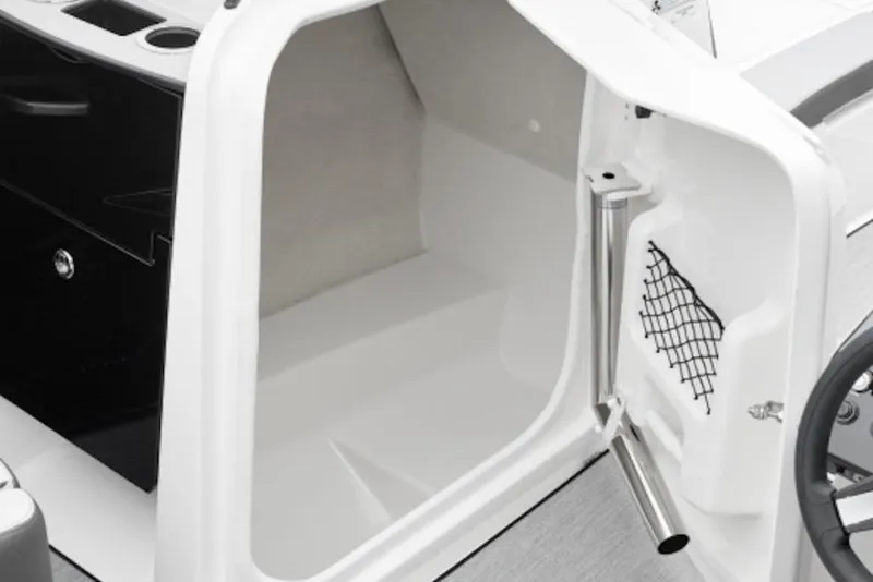 Slide: The Image of 2026 Yamaha Boats AR250 interior storage compartment with open door and netting. - 3