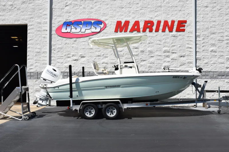 Slide: The Image of 2024 Stingray 216 CC boat on trailer at GSPS Marine dealership. - 1