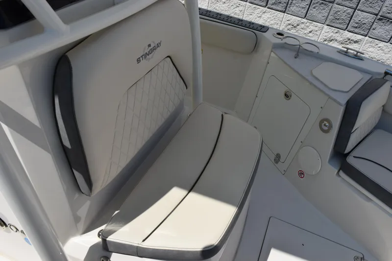 Slide: The Image of 2024 Stingray 216 CC boat interior seating with storage compartment. - 13