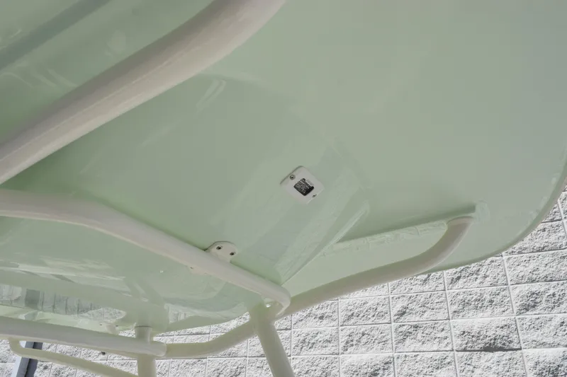 Slide: The Image of 2024 Stingray 216 CC boat underside with white framework and light green finish. - 14