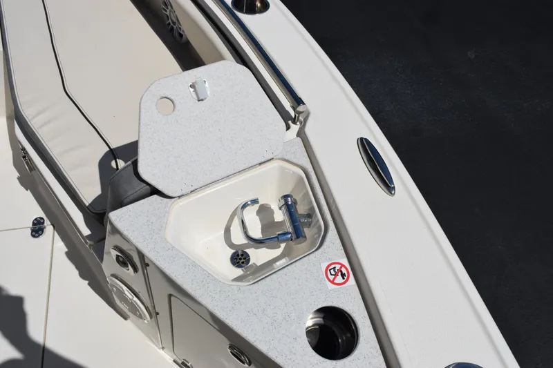 Slide: The Image of 2024 Stingray 216 CC boat interior with sink and seating area. - 15