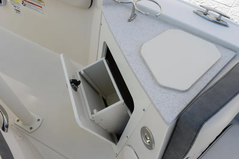 Slide: The Image of 2024 Stingray 216 CC boat interior storage compartment and seating detail. - 20