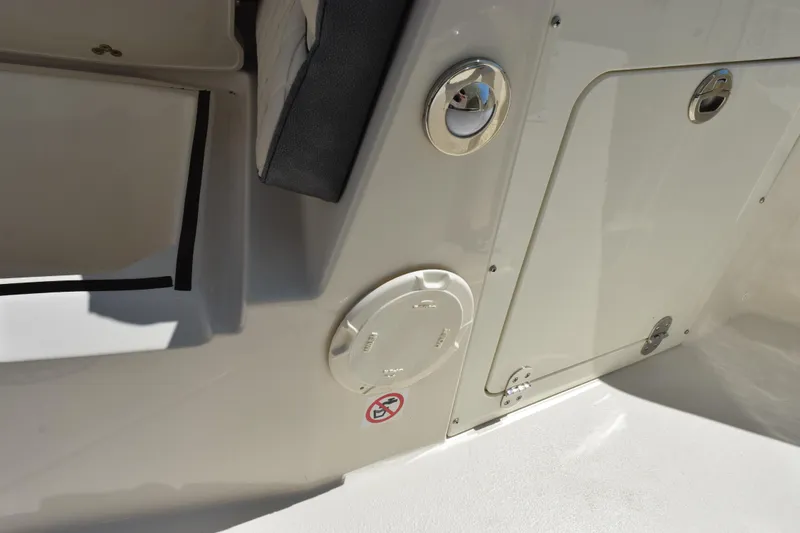 Slide: The Image of 2024 Stingray 216 CC boat interior detail with storage compartment and seating. - 22