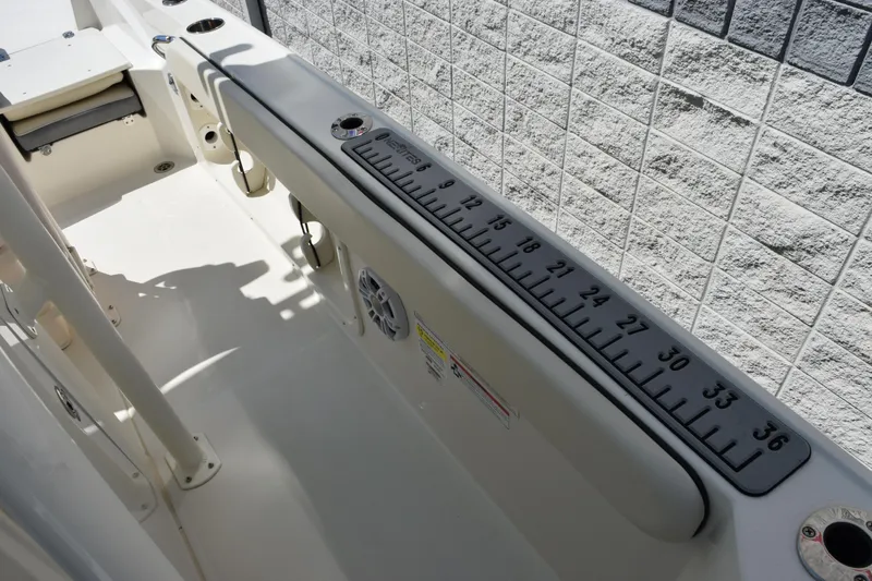 Slide: The Image of 2024 Stingray 216 CC boat interior with measuring ruler and seating area. - 25