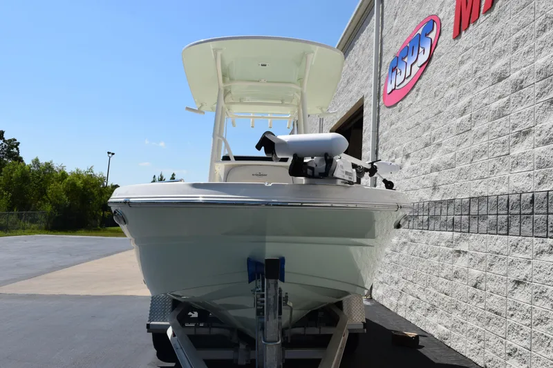 Slide: The Image of 2024 Stingray 216 CC boat on trailer outside dealership building. - 3
