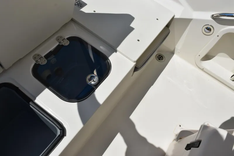 Slide: The Image of 2024 Stingray 216 CC boat interior with storage compartments and seating area. - 31