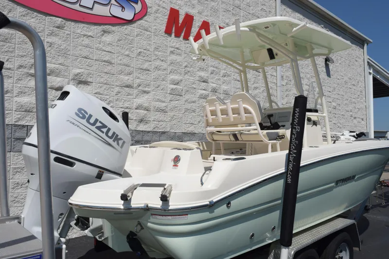 Slide: The Image of 2024 Stingray 216 CC boat with Suzuki engine displayed outdoors. - 4