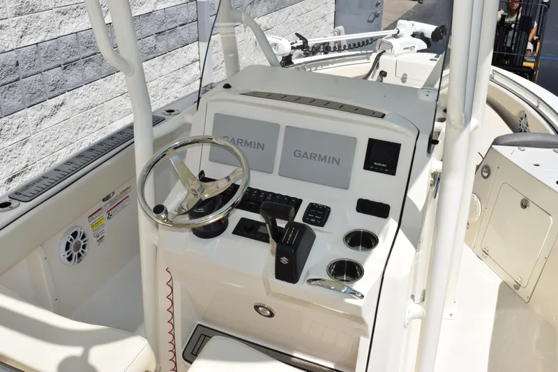 Slide: The Image of 2024 Stingray 216 CC boat dashboard with Garmin navigation system and steering wheel. - 8