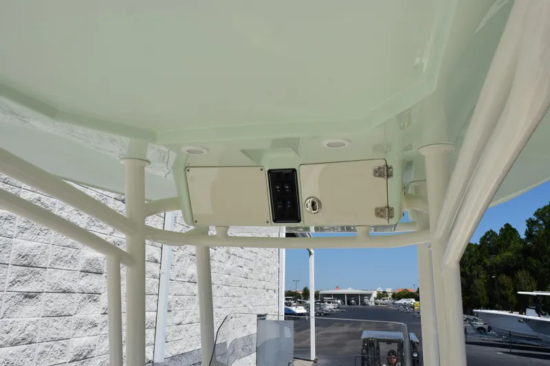 Slide: The Image of 2024 Stingray 216 CC boat console with storage compartment and control panel. - 9
