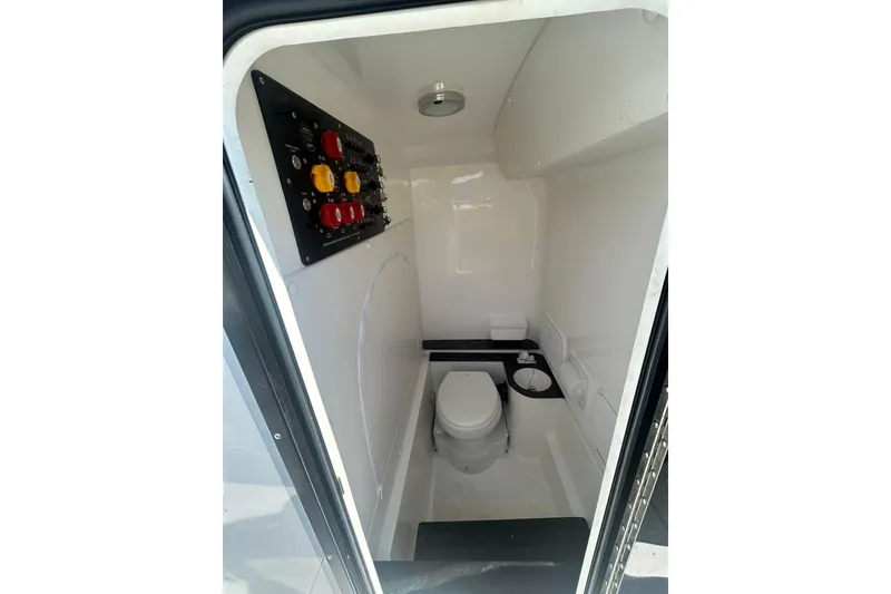 Slide: The Image of 2023 Fountain 38TE CC boat with open storage compartment and cup holders. - 12