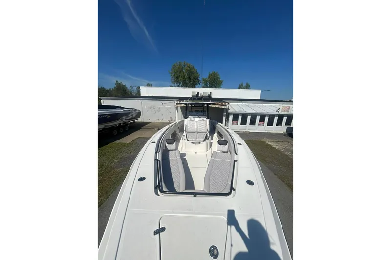 Slide: The Image of 2023 Fountain 38TE CC boat interior with seating and console, showcasing modern design. - 15