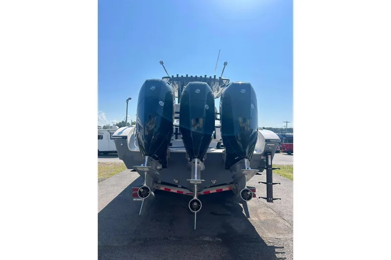 Slide: The Image of 2023 Fountain 38TE CC boat on trailer under clear blue sky. - 9