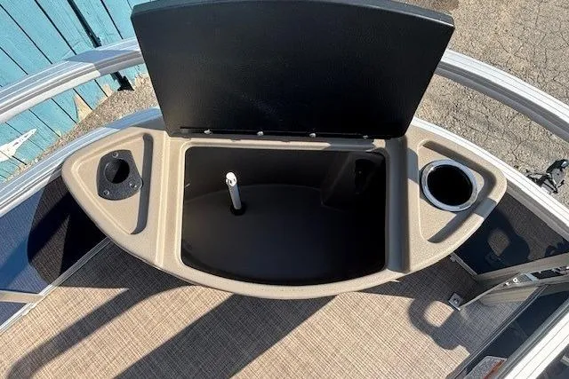 Slide: The Image of 2024 Sun Tracker Bass Buggy 18 DLX boat storage compartment with cup holders. - 11
