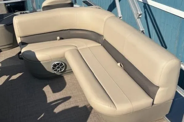 Slide: The Image of 2024 Sun Tracker Bass Buggy 18 DLX pontoon boat with beige seating and speaker. - 17