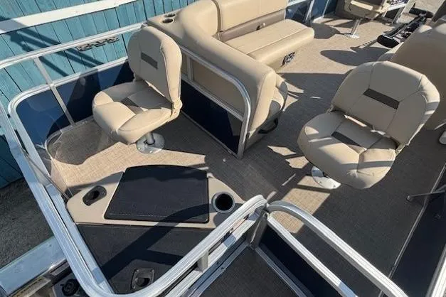 Slide: The Image of 2024 Sun Tracker Bass Buggy 18 DLX interior with beige seating and fishing deck. - 20