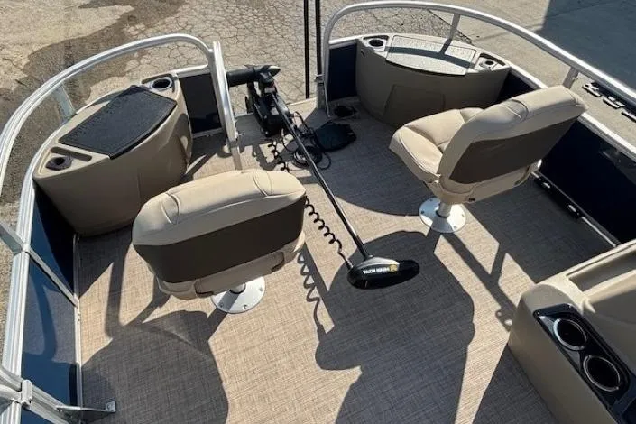 Slide: The Image of 2024 Sun Tracker Bass Buggy 18 DLX interior with seating and fishing equipment. - 5