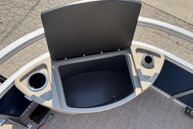 Slide: The Image of 2024 Sun Tracker Bass Buggy 18 DLX storage compartment with cup holders on a pontoon boat. - 9