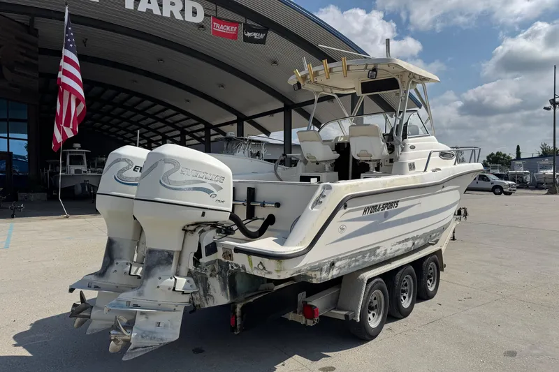 Slide: The Image of 1999 Hydra-Sports VECTOR 2650 WA boat with dual Evinrude engines on a trailer. - 4