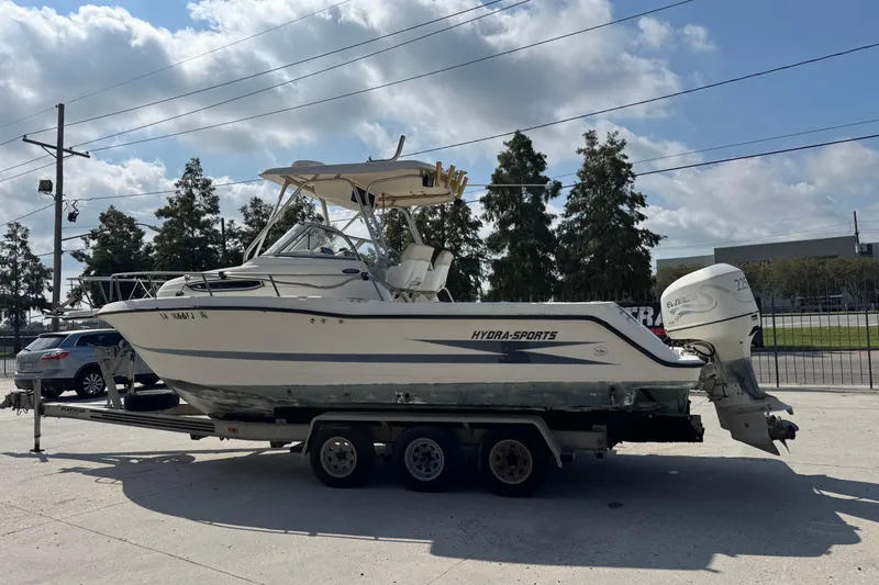 Slide: The Image of 1999 Hydra-Sports VECTOR 2650 WA boat on trailer, parked outdoors under a cloudy sky. - 6
