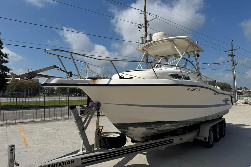 Slide: The Image of 1999 Hydra-Sports VECTOR 2650 WA boat on trailer, parked outdoors under blue sky. - 7