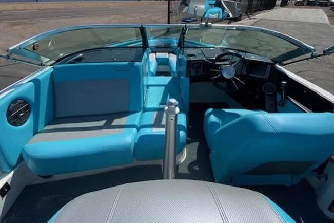 Slide: The Image of 2018 MasterCraft ProStar boat interior with blue seating and steering wheel. - 1