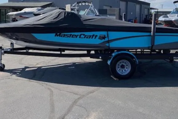 Slide: The Image of 2018 MasterCraft ProStar boat on trailer, covered, parked outdoors. - 4
