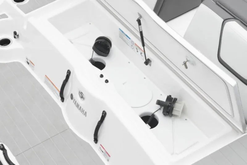 Slide: The Image of 2026 Yamaha Boats SX250 interior storage compartment with open hatch and visible components. - 2
