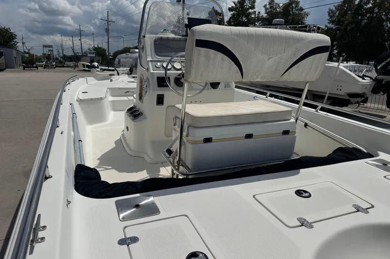 Slide: The Image of 2005 Bay Stealth 2230 boat interior with seating and console, parked outdoors. - 10