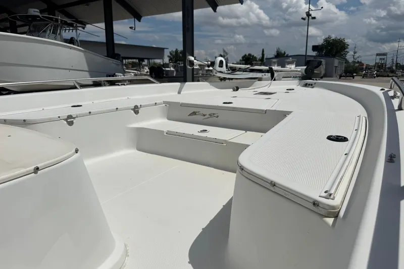 Slide: The Image of 2005 Bay Stealth 2230 boat interior with white deck and storage compartments. - 15