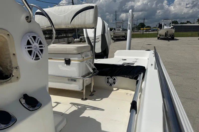 Slide: The Image of 2005 Bay Stealth 2230 boat interior with seating and speakers, parked outdoors. - 17