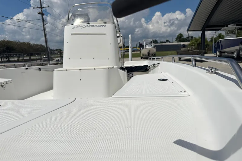 Slide: The Image of 2005 Bay Stealth 2230 boat, white deck, clear sky, outdoor display. - 18