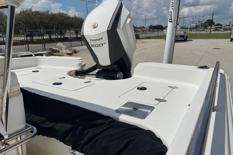 Slide: The Image of 2005 Bay Stealth 2230 boat with Evinrude 200 HP motor, docked outdoors. - 22