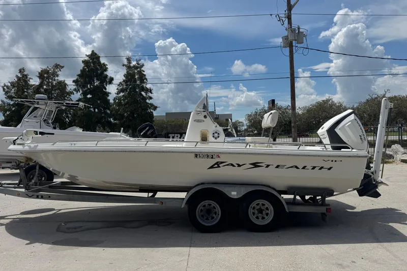 Slide: The Image of 2005 Bay Stealth 2230 boat on trailer under cloudy sky. - 3