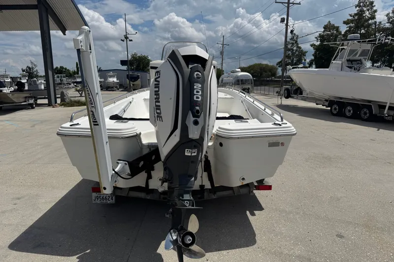 Slide: The Image of 2005 Bay Stealth 2230 boat with Evinrude motor, parked outdoors on a sunny day. - 8