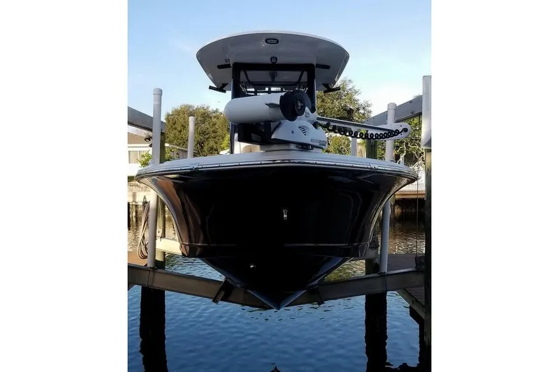Slide: The Image of 2019 Sea Hunt BX 25 FS boat on lift, front view, docked in marina. - 1