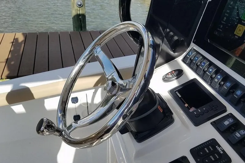 Slide: The Image of Steering wheel and controls of 2019 Sea Hunt BX 25 FS boat. - 6