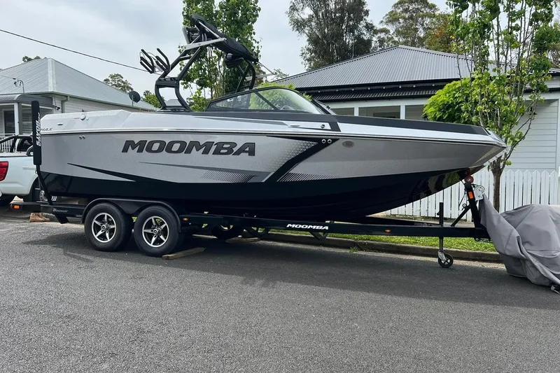 Slide: The Image of 2020 Moomba Max boat on trailer parked in residential area. - 0