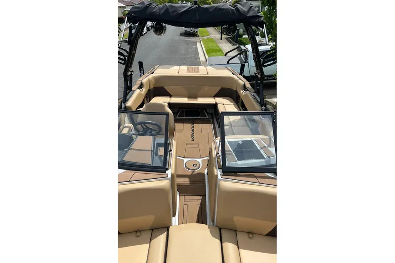 Slide: The Image of 2020 Moomba Max boat interior with tan seating and open windshield. - 1