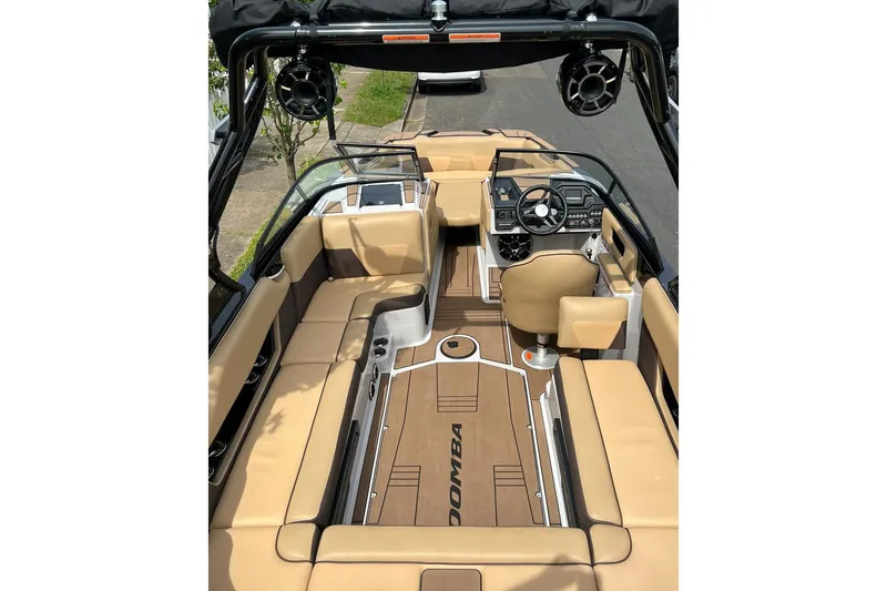 Slide: The Image of 2020 Moomba Max boat interior with tan seating and modern dashboard. - 4