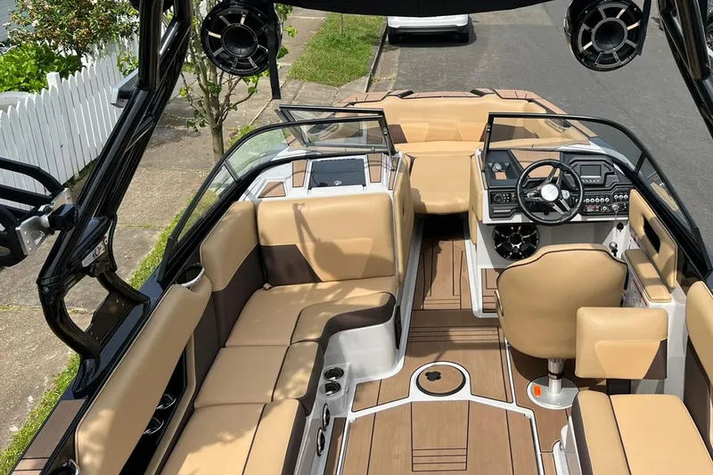 Slide: The Image of 2020 Moomba Max boat interior with tan seating and modern dashboard. - 5