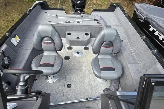 Slide: The Image of 2022 Tracker Pro Guide V-175 WT boat interior with two seats and carpeted flooring. - 14