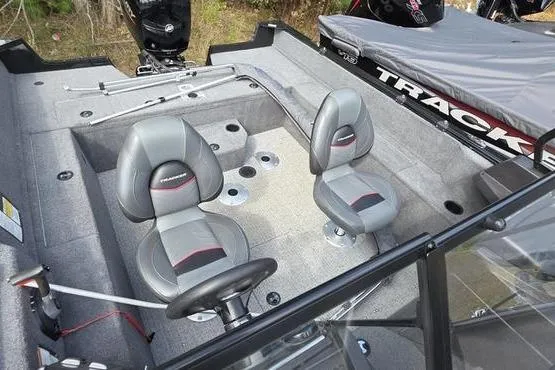 Slide: The Image of 2022 Tracker Pro Guide V-175 WT boat interior with two gray seats and fishing rod holders. - 5