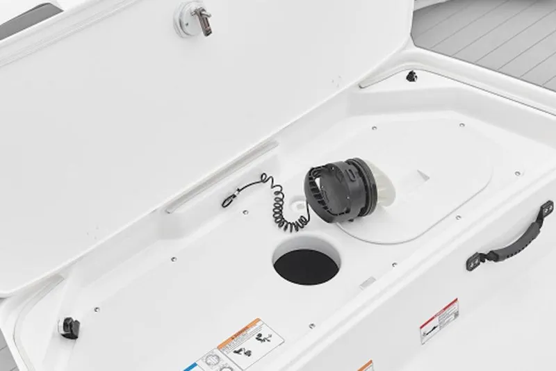 Slide: The Image of 2026 Yamaha Boats SX190 storage compartment with safety features and secure latch. - 3