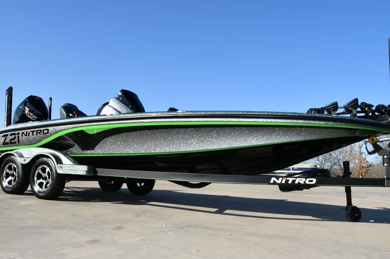 Slide: The Image of 2020 Nitro Z21 Pro bass boat on trailer, sleek design, green accents. - 0