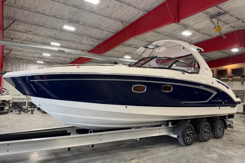 Slide: The Image of 2015 Chaparral 327 SSX boat on trailer in indoor storage facility. - 1
