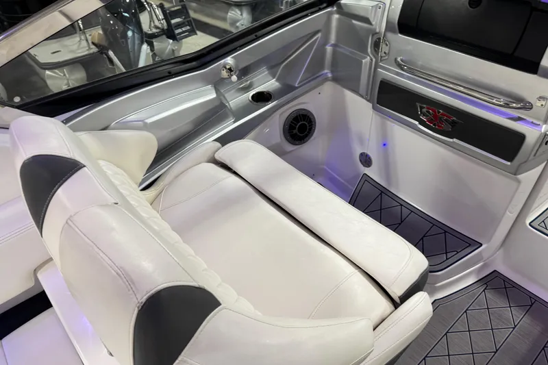 Slide: The Image of 2015 Chaparral 327 SSX boat interior with white seating and modern design elements. - 10