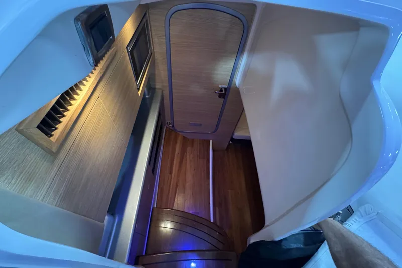 Slide: The Image of 2015 Chaparral 327 SSX cabin interior with wood flooring and modern design. - 13