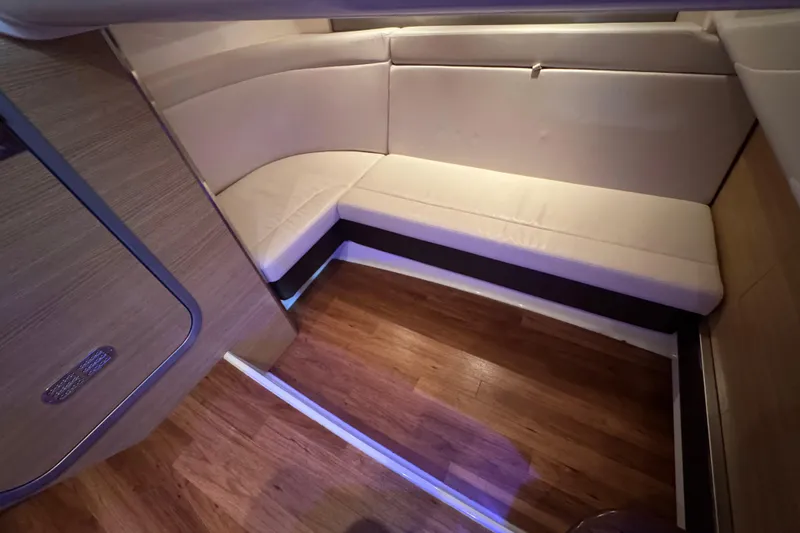 Slide: The Image of 2015 Chaparral 327 SSX interior with wood flooring and cream seating. - 14
