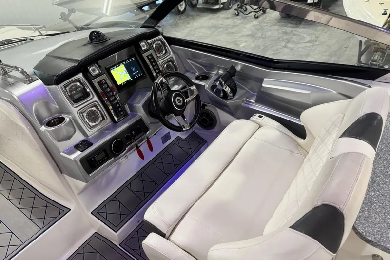 Slide: The Image of 2015 Chaparral 327 SSX boat cockpit with modern dashboard and plush seating. - 16