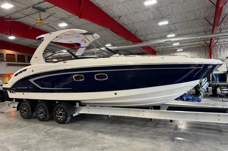 Slide: The Image of 2015 Chaparral 327 SSX boat on trailer in indoor showroom. - 2